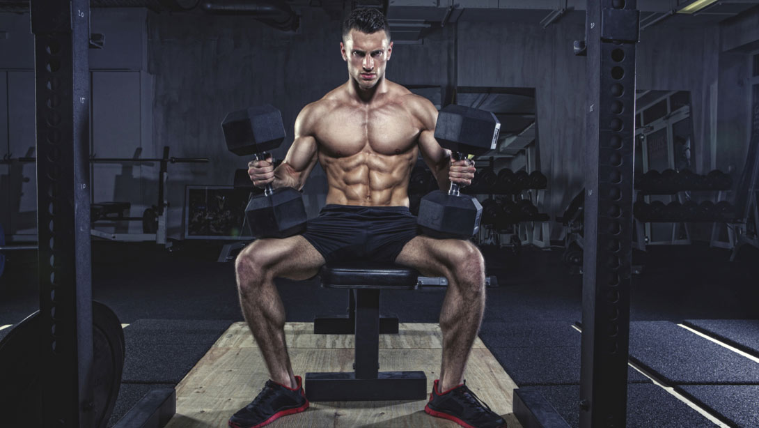 Man Seated With Heavy Dumbbells