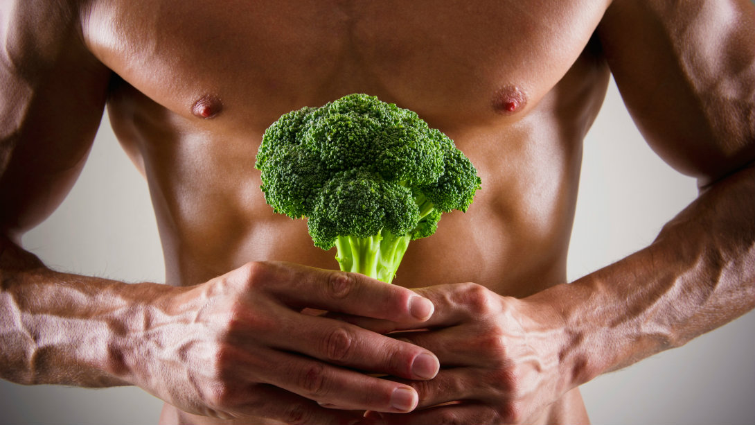 man holding broccoli stem