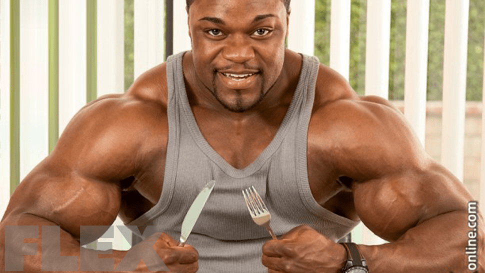 Mr Olympia Brandon Curry holding a knife and fork for The Beginner Bodybuilder’s 4-Week Meal Plan