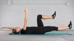 Fit person performing the deadbug exercise