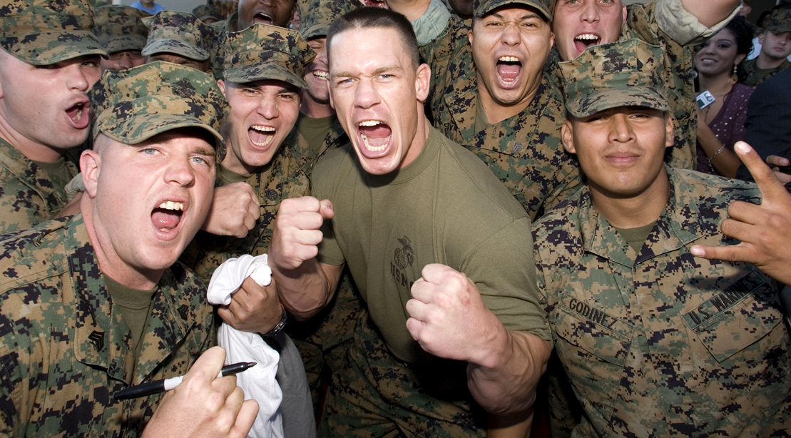 Former WWE prowrestler cheering with a group of united states armed forces