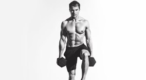 Muscular man performing dumbbell lunge