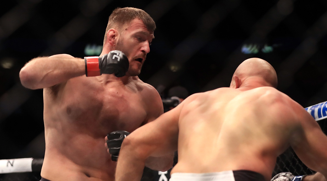 Stipe Miocic Delivers A Body Collapsing Haymaker on Junior Dos Santos at UFC 211 | Muscle & Fitness
