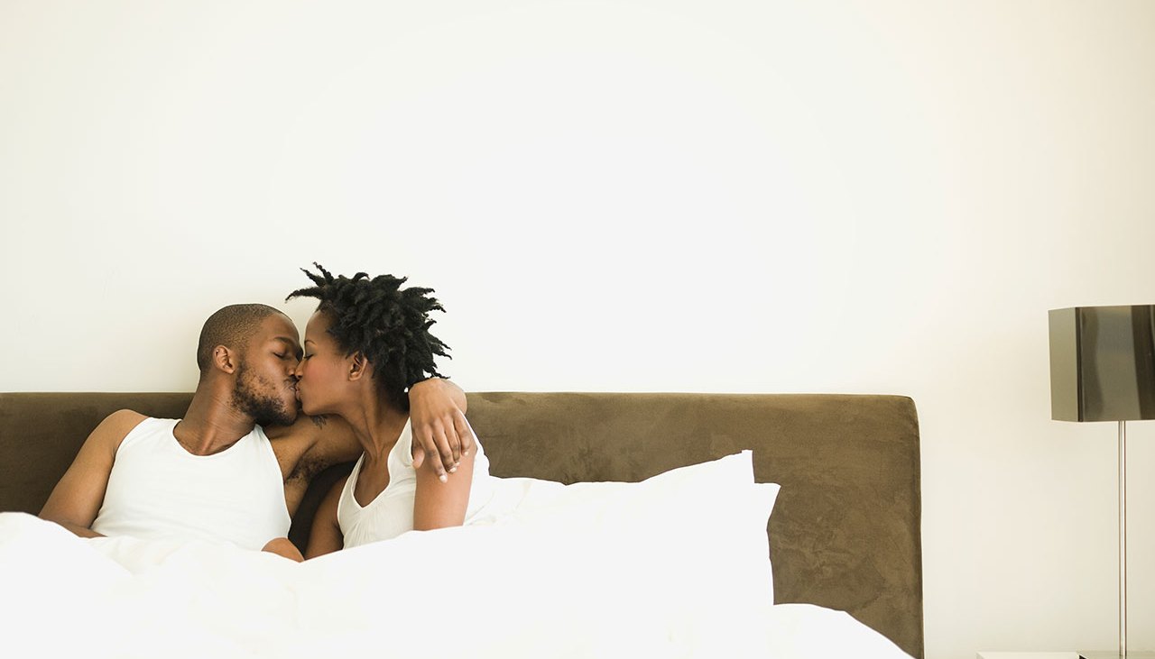 Couple Kissing In Bed