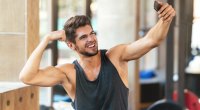 Man-In-The-Gym-Flexing-His-Biceps-Taking-A-Selfie