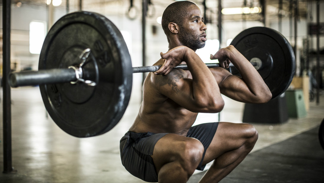 man performing barbell front squat exercise