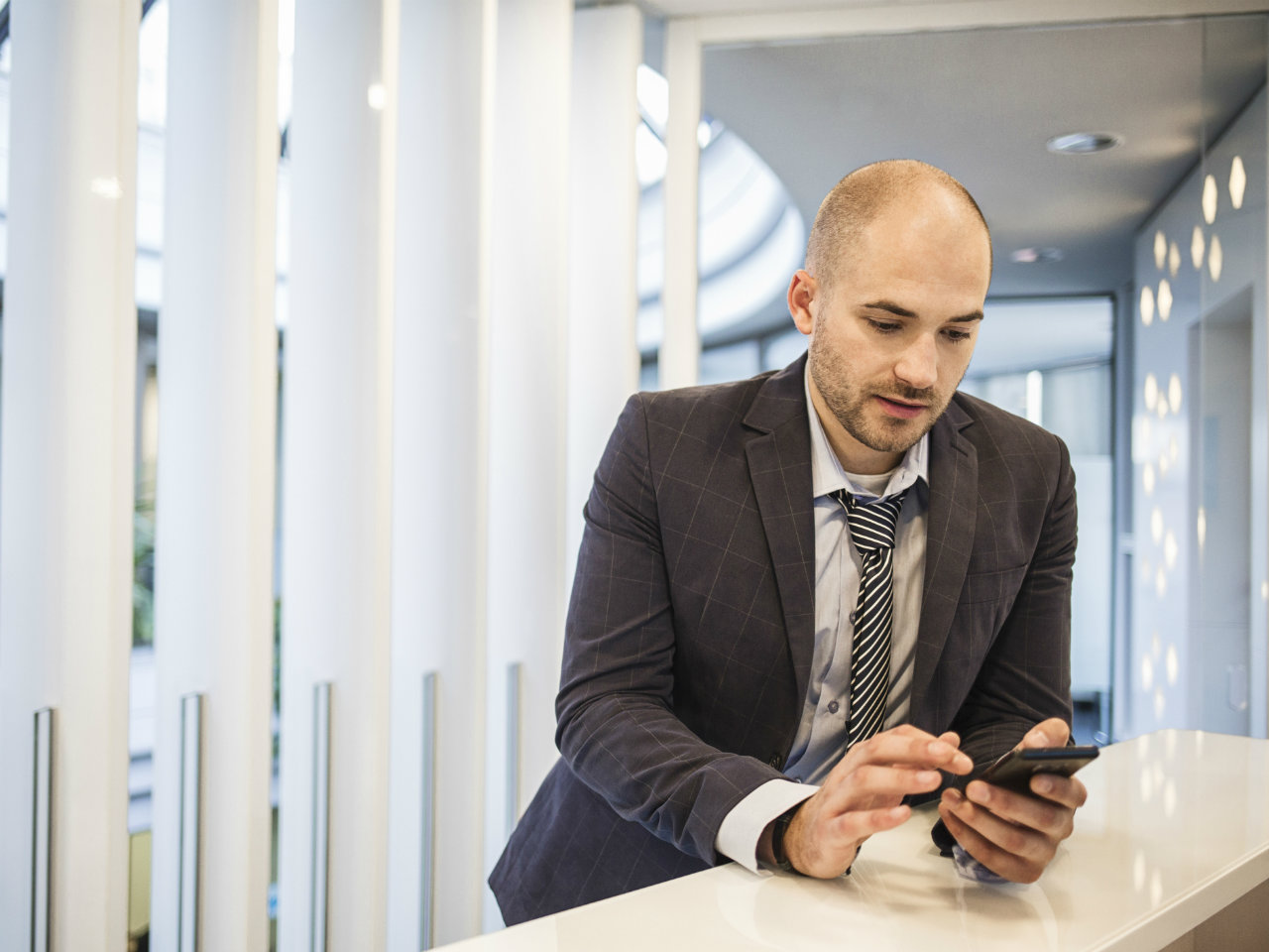 Bald Man at Work on Cell Phone
