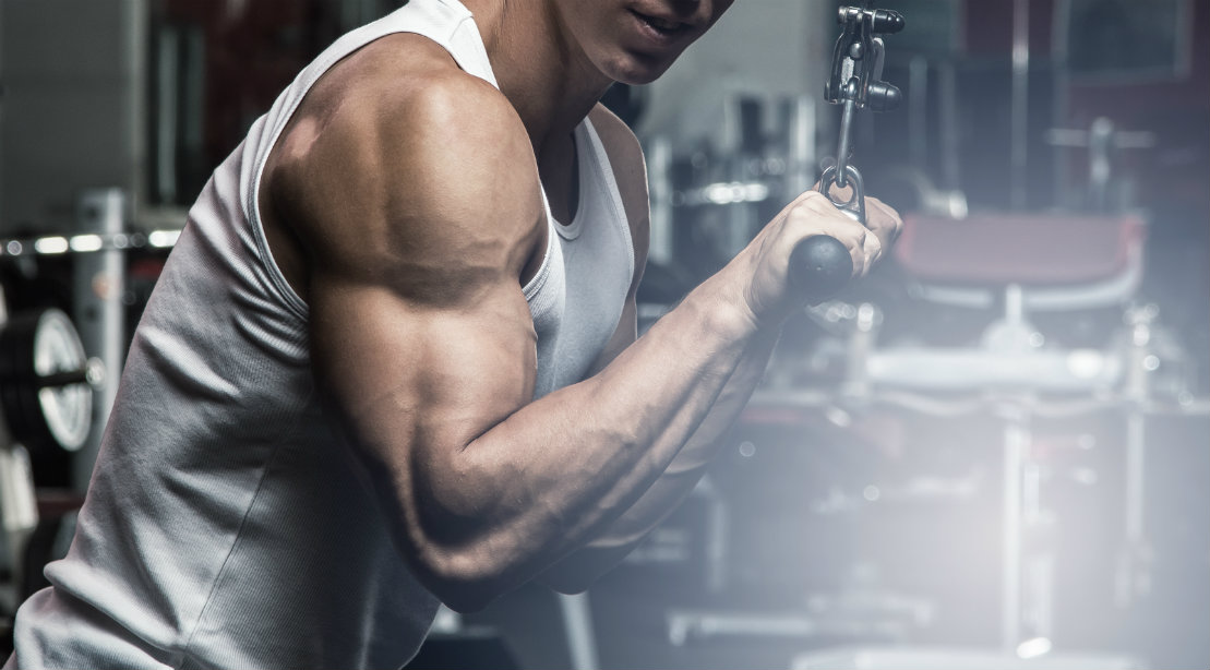 Man Performing Triceps Pushdown At The Gym