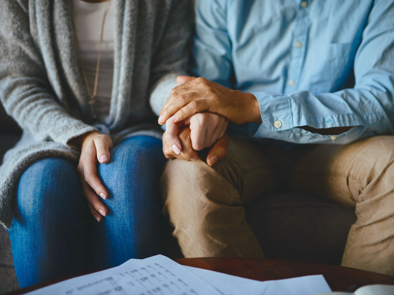 Couple Holding Hands on Couch