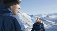 Man drinking water during ski break