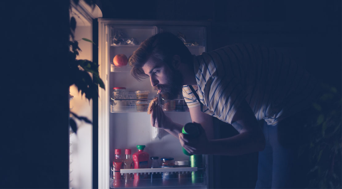 Man having a late night snack to gain healthy weight