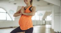Pregnant woman doing yoga pose and exercises after childbirth