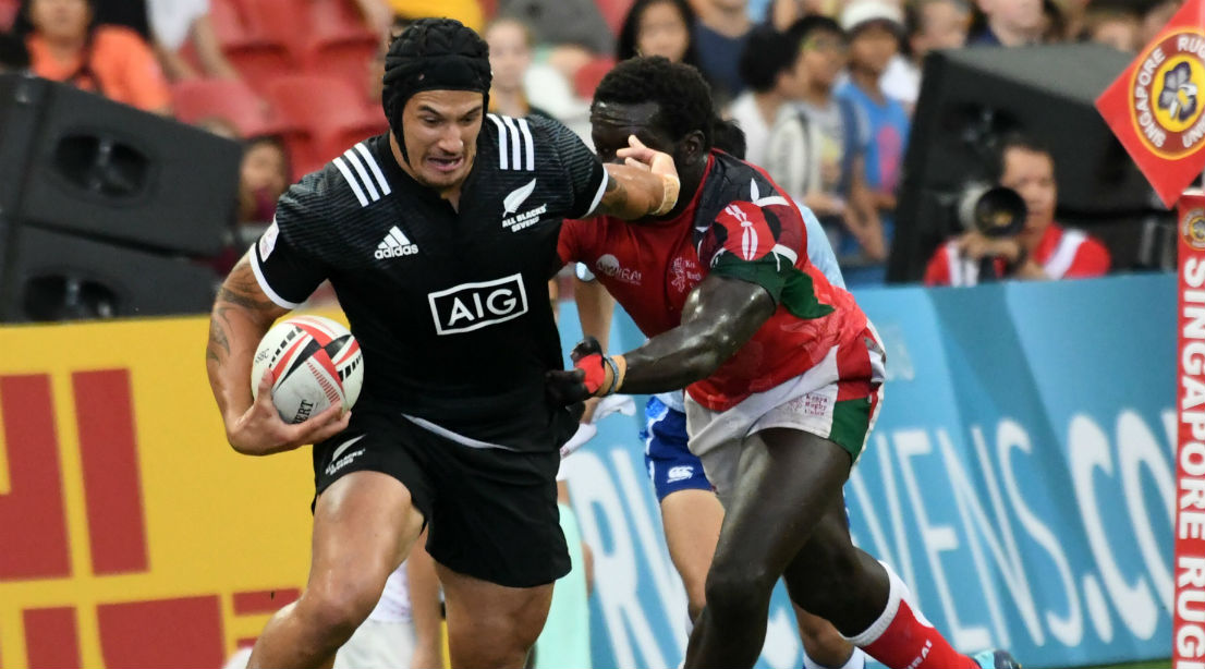 New Zealand's Trael Joass (L) runs with the ball against Kenya during the fifth place cup semi-final of the HSBC Singapore Rugby Sevens tournament in Singapore on April 29, 2018.