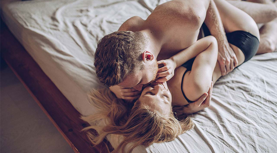 Couple in Bed Kissing 