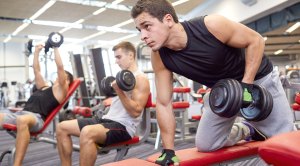 Three men working out in the gym with different exercises