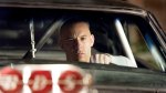 Vin Diesel holds the steering wheel of a customized Dodge Charger