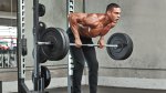 Fit lean man working out with a the back exercise bent over barbell row exercise