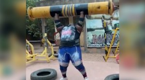 Powerlifter Iron Biby performing a log press. 