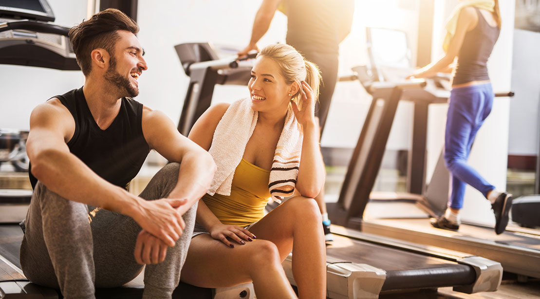 Man and woman flirting at gym