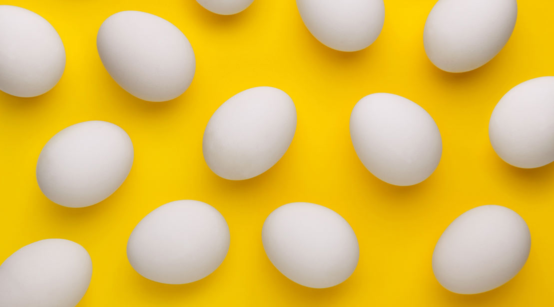 A photo of eggs against a yellow background.