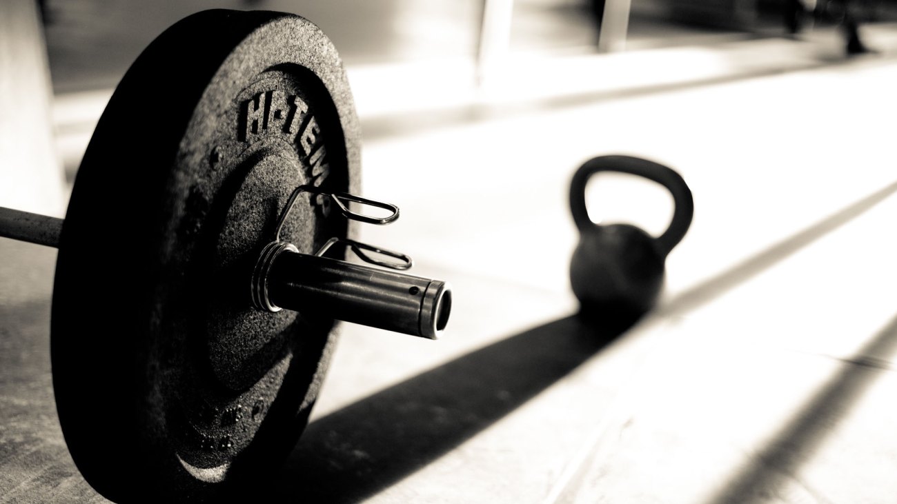 Barbell and Kettle-bell casting a shadow