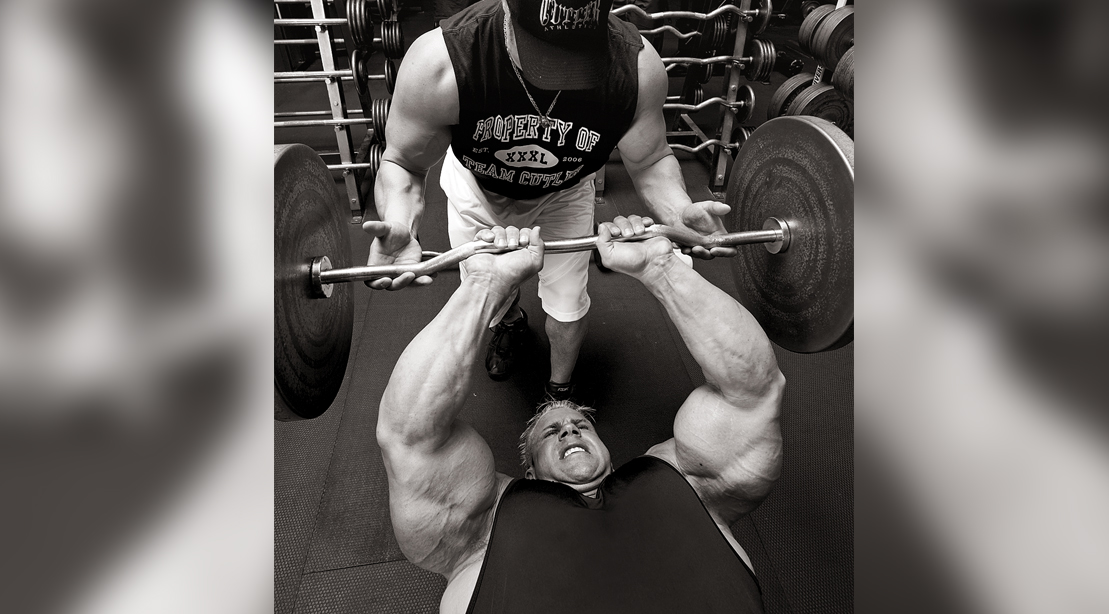 Bodybuilder and Mr. Olympia winner Jay Cutler working out his tricep muscles with a close grip bench press with a spotter