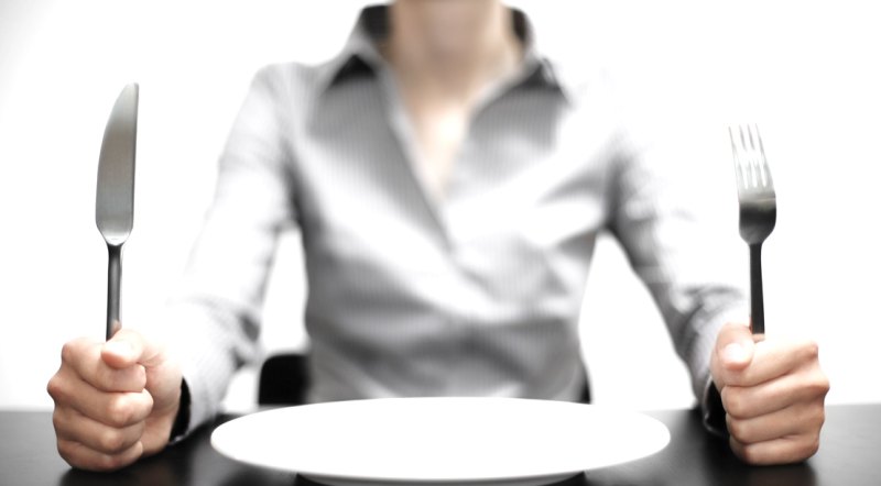 Woman-Holding-Knife-Fork-Empty Plate