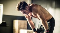 Young Man Exhausted at the Gym from poor strength training mistakes
