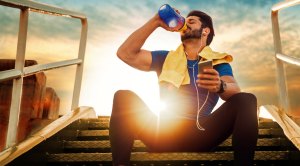 Man drinking water to stay hydrated after following our hydration tips to avoid dehydration