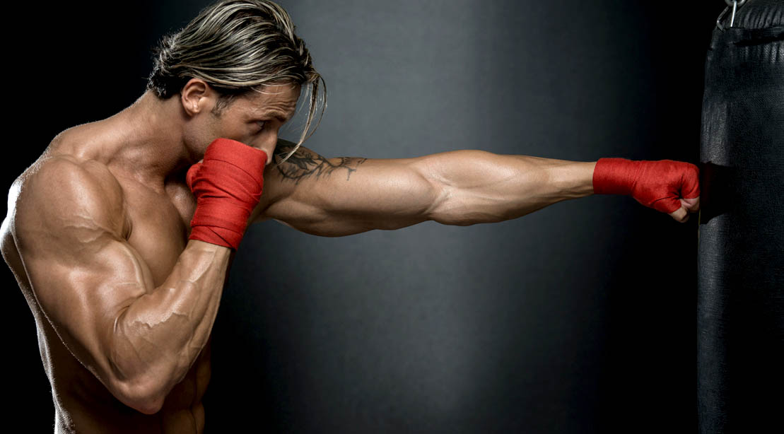 Muscular-Boxer-Punching-Heavy-Bag