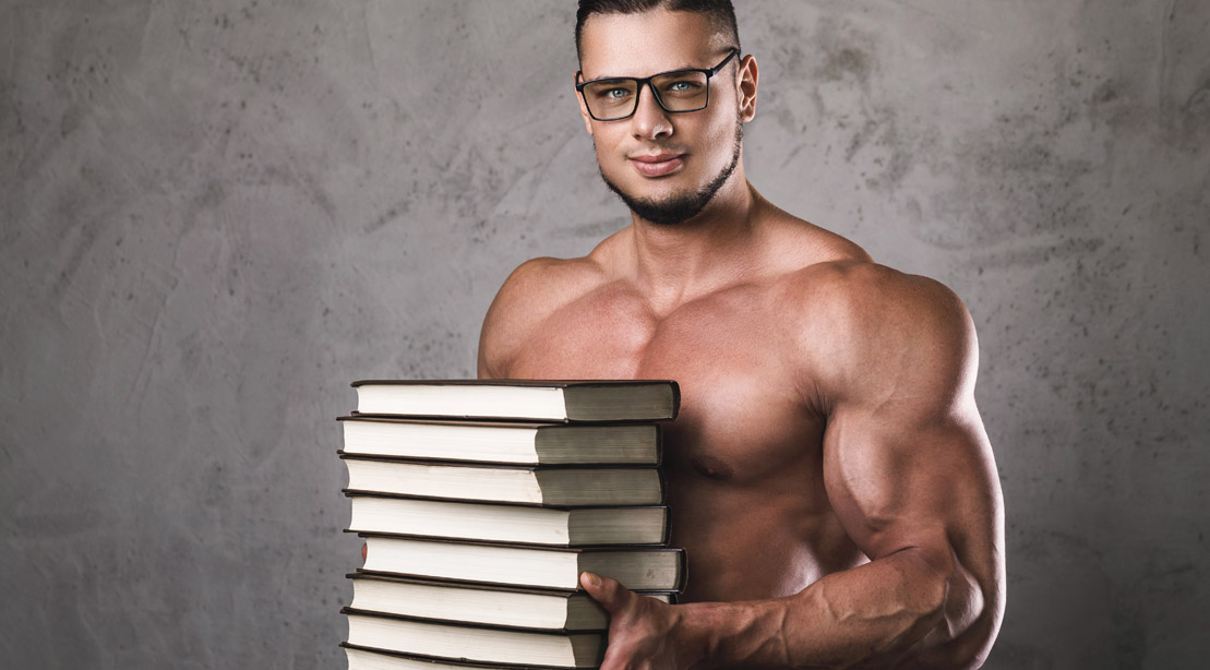 Muscular-Man-Wearing-Glasses-Holding-Stack-of-Books