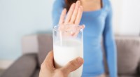Woman-Rejecting-Glass-Of-Milk