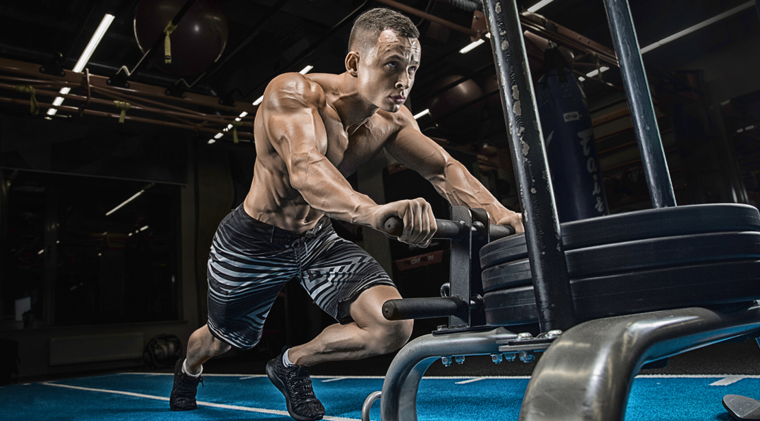 Topless-Muscular-Male-Pushing-Prowler-Sled