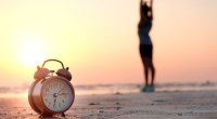 Morning-Alarm-Clock-On-Beach-Girl-Stretching-Sunrise
