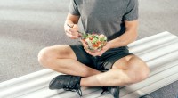 Man sits on a bench and eats salad to boost his sanity