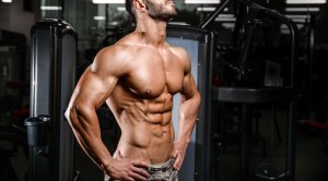 Fit man with a muscular physique showing off his shredded abs that reveals the lower abs and muscular oblique muscles
