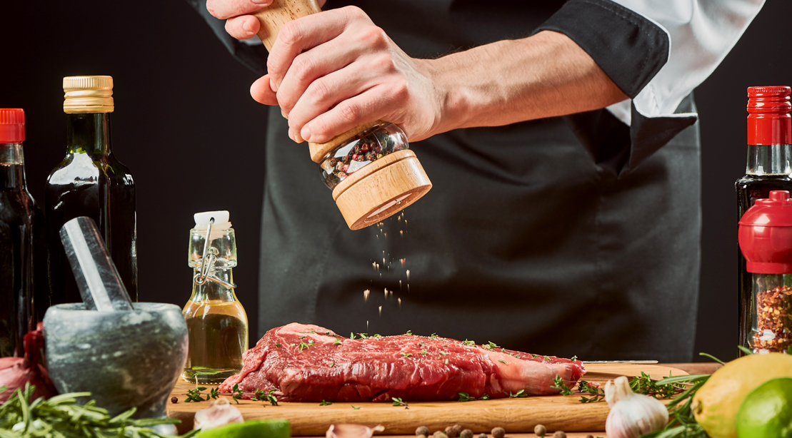 Chef-Seasoning-Steak-Meat-With-Pepper-Grinder