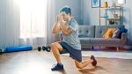 Male-Performing-Split-Squat-In-Living-Room-Home-Gym