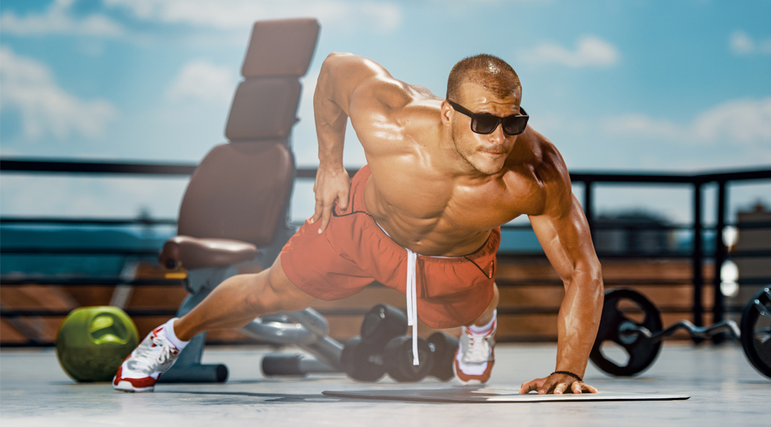 Bodybuilder-Wearing-Sunglasses-Doing-One-Handed-Pushup-Outdoors