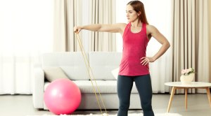 Fitness-Woman-Working-Out-At-Home-With-Bands-And-Swiss-Ball