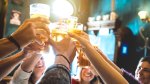 Group-Of-Friends-Cheering-With-Glass-Of-Beer