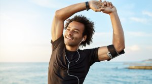 Happy-Fit-Man-Stretching-and-exercise-is-medicine-While-Listening-To-Ear-Phones