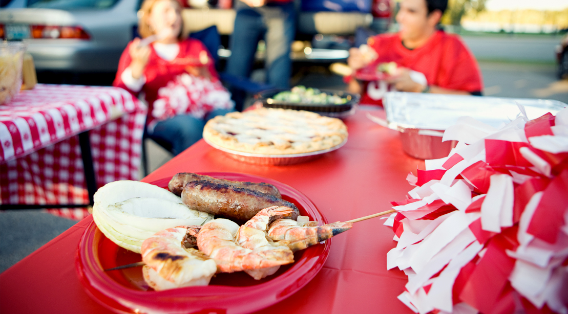Shrimp-Skewers-and-Sausage-On-Picnic-Table-At-Tailgate-Party