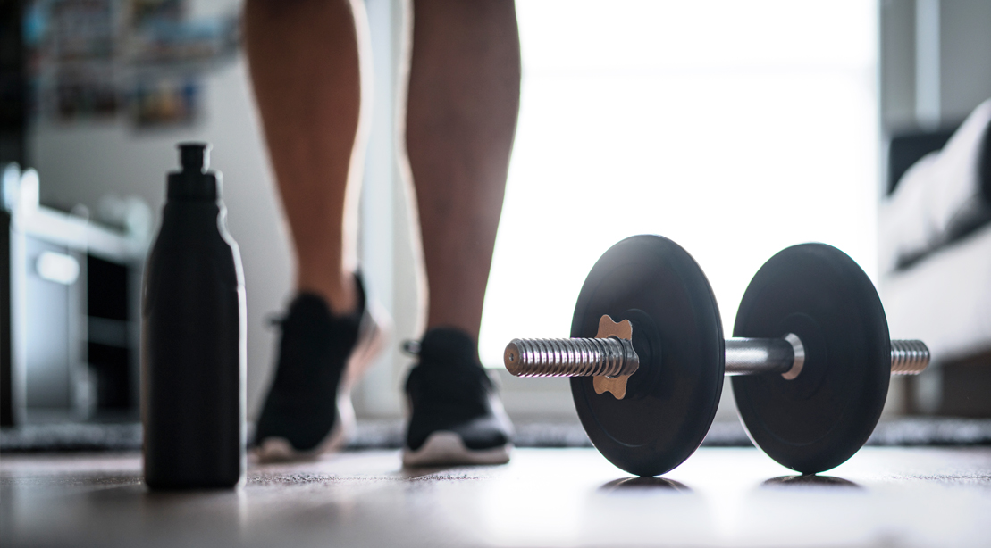 Walking-Around-Living-Room-With-A-Dumbbell-On-The-Floor