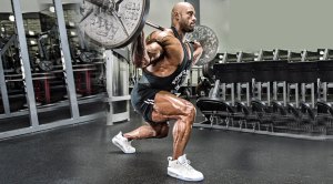 Professional bodybuilder Juan Morel performing a barbell lunge stance squat exercise