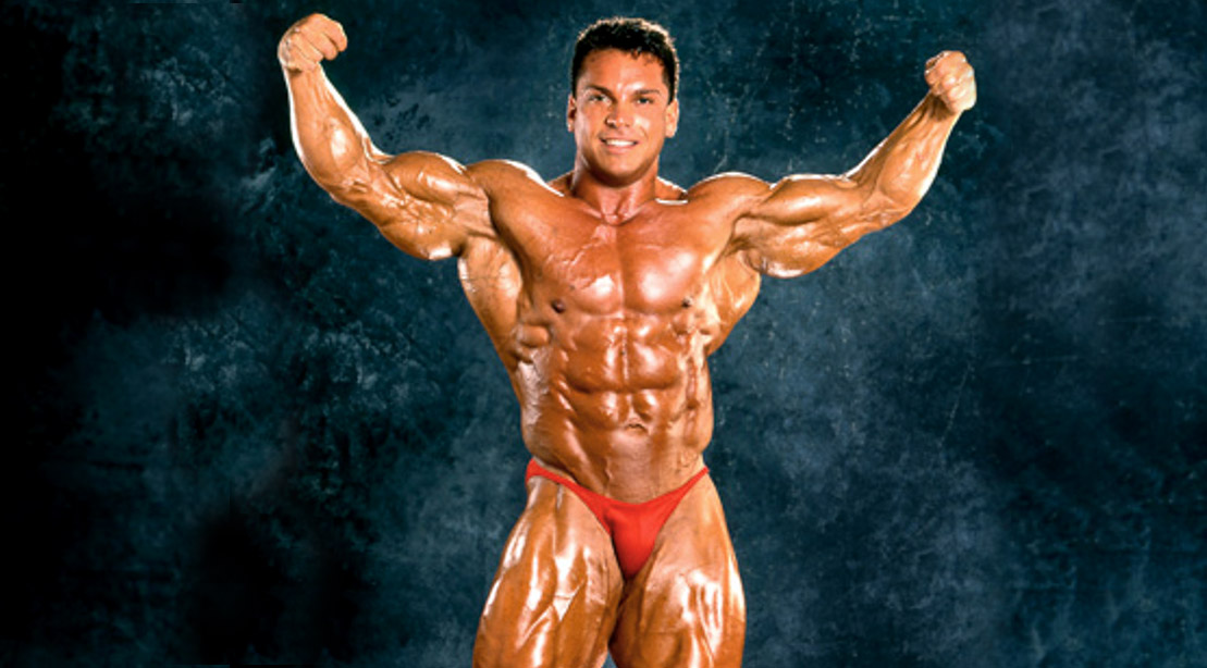 Bodybuilder Rich Gaspari posing and flexing his biceps and arm muscles