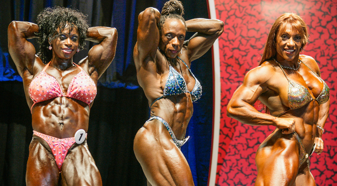 Former Ms. Olympia Iris Kyle and Dayana Cadeau posing in a female bodybuilding competition