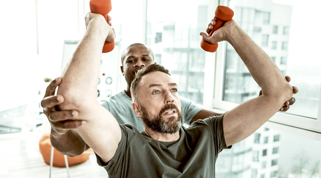 Aging man past age 40 going through physical therapy to restart his muscle memory
