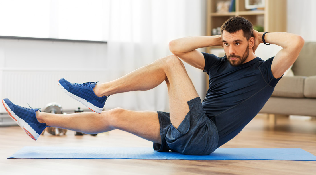 Fitness Man Doing Twisting Crunches At Home
