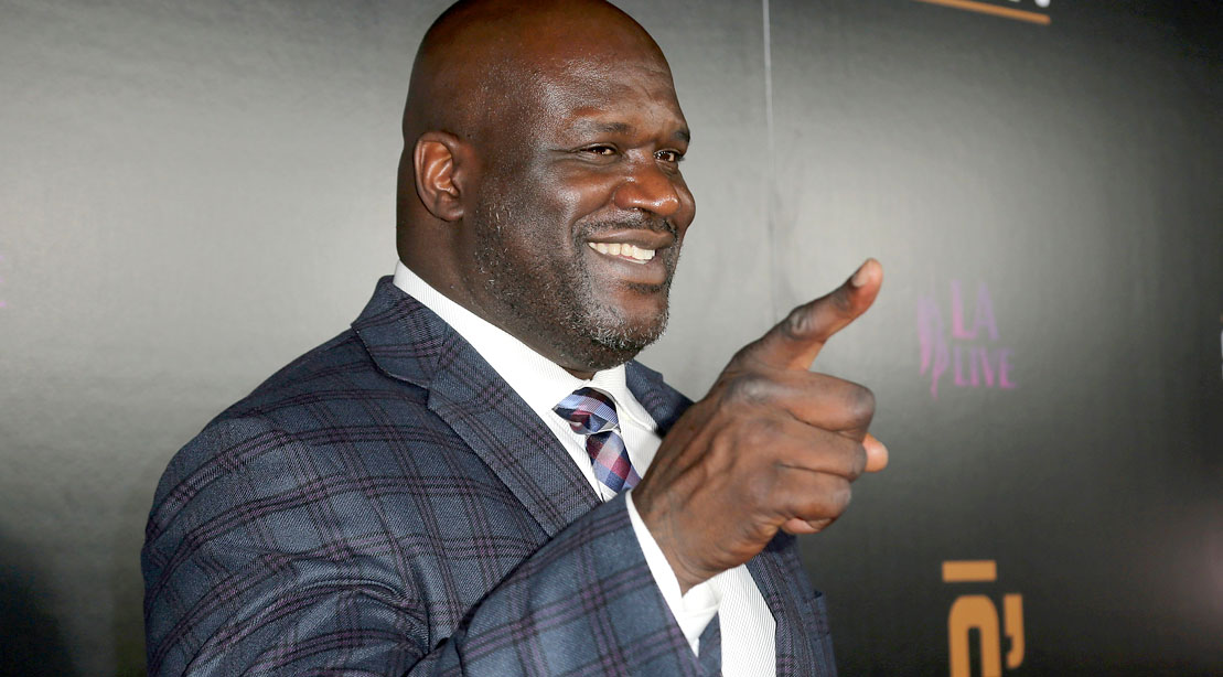 Former NBA basketball player for the LA Lakers Shaquille O'Neal pointing in a suit